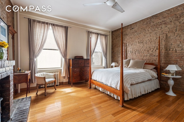 138 Lexington Ave Ph, Ph, New York City, NY 10016 - bedroom with brick wall, light wood finished floors, radiator, ceiling fan, and ornamental molding