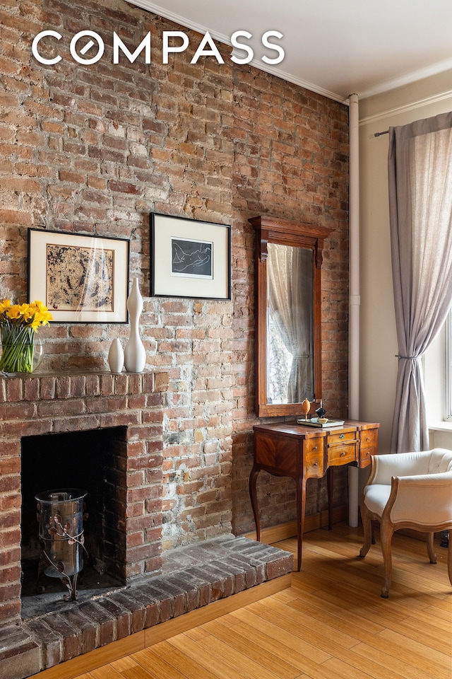 138 Lexington Ave Ph, Ph, New York City, NY 10016 - living room featuring wood finished floors, ornamental molding, and a brick fireplace