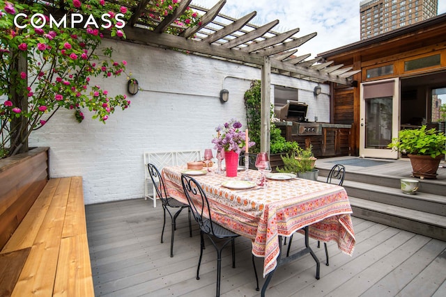 wooden deck featuring a pergola, outdoor dining area, and exterior kitchen
