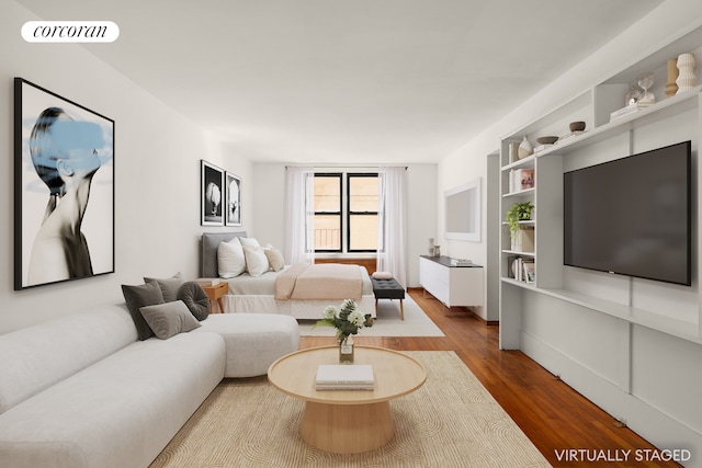 living area featuring visible vents and wood finished floors