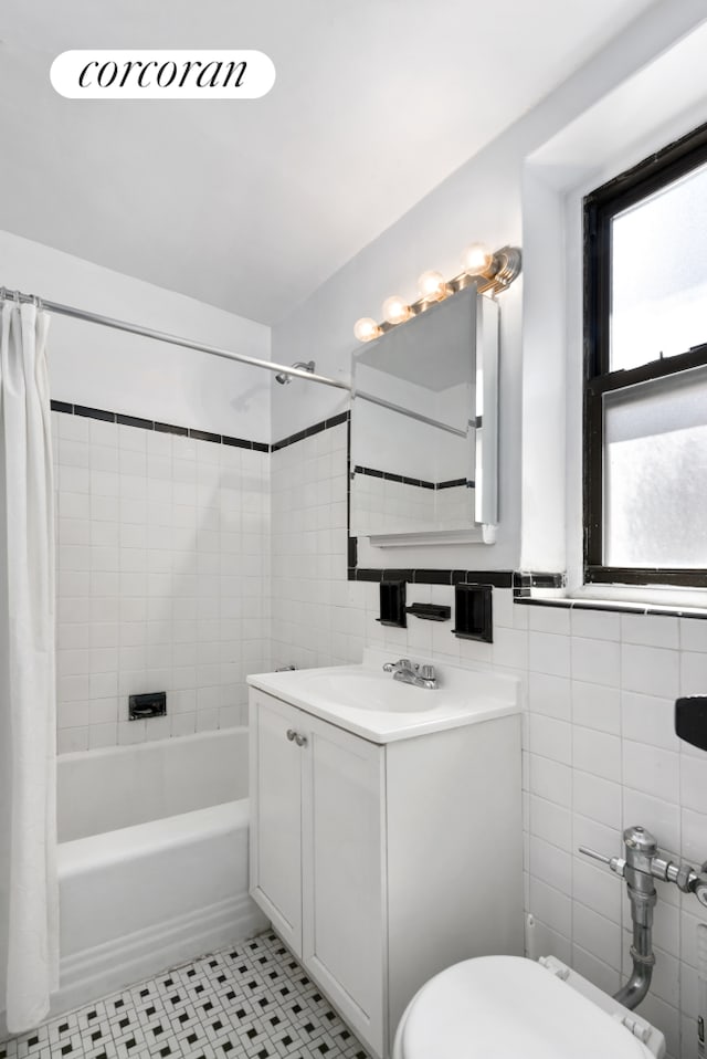 1420 York Ave Unit 4G, New York City, NY 10021 - full bathroom featuring shower / tub combo, vanity, toilet, tile walls, and tile patterned floors