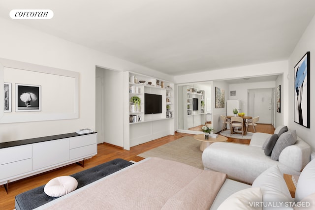 living room with visible vents and light wood-style flooring