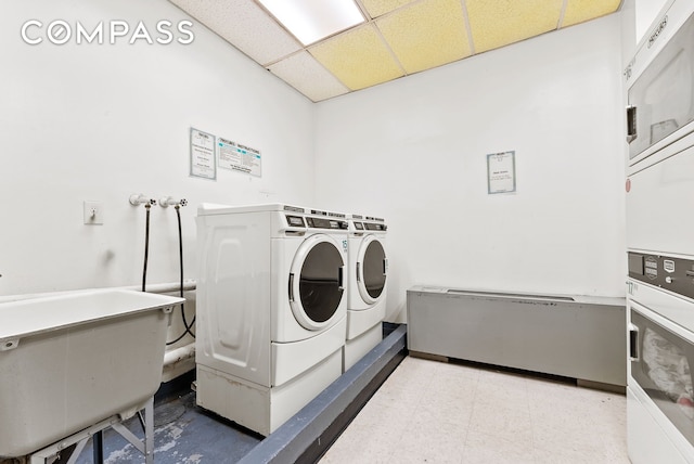 shared laundry featuring separate washer and dryer, stacked washer / drying machine, and light floors