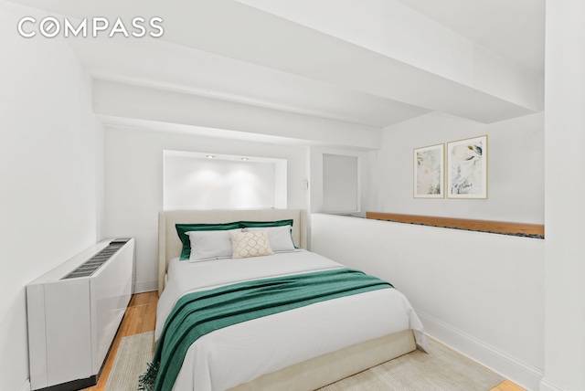 bedroom with wood finished floors and baseboards
