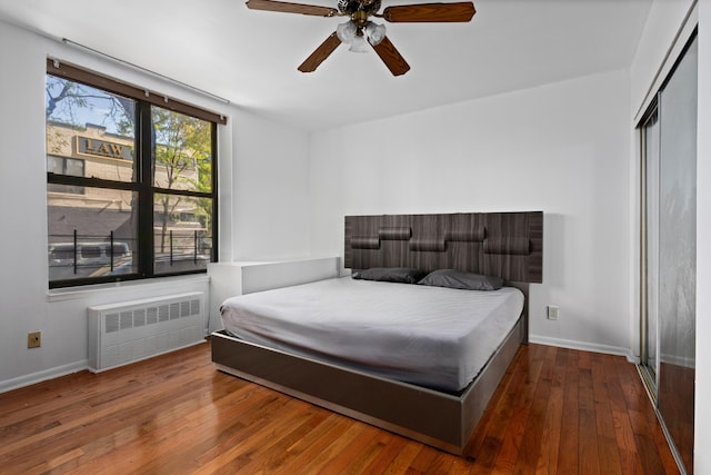 68 Stratford Rd Unit 1A, New York City, NY 11218 - bedroom with radiator heating unit, wood-type flooring, a closet, and a ceiling fan