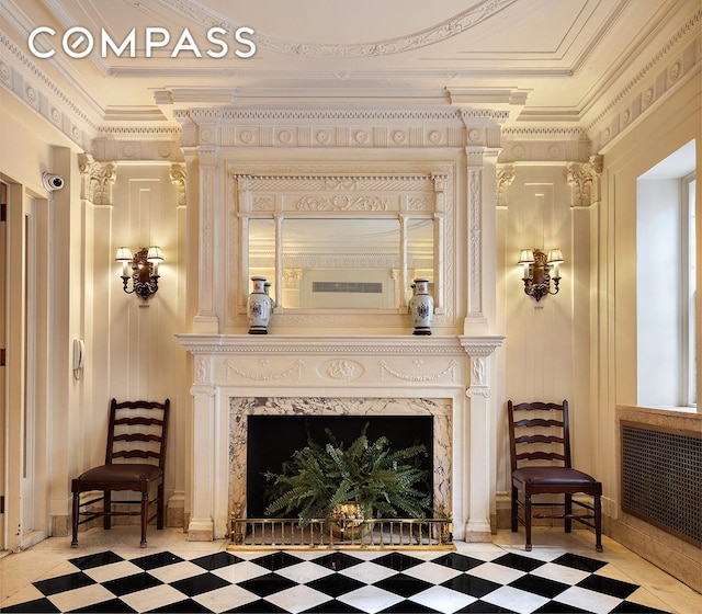 1349 Lexington Ave Unit 8C, New York City, NY 10128 - detailed view of a fireplace, tile patterned floors, crown molding, and radiator