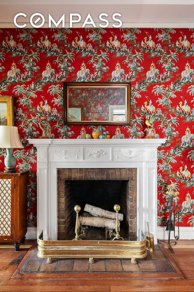 1349 Lexington Ave Unit 8C, New York City, NY 10128 - detailed view of wood finished floors, a fireplace, wallpapered walls, and baseboards