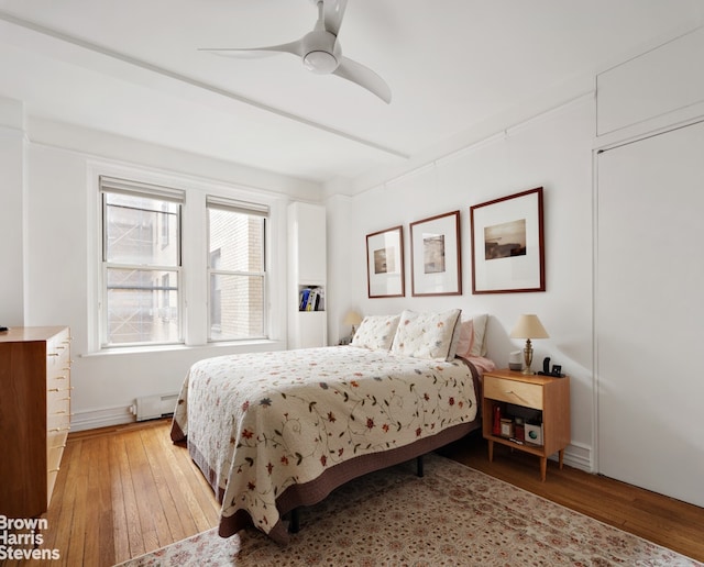 245 W 107th St Unit 4E, New York City, NY 10025 - bedroom featuring baseboard heating, light wood finished floors, and ceiling fan
