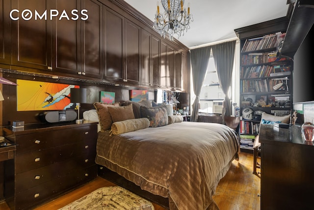 bedroom featuring dark wood-style floors and a chandelier