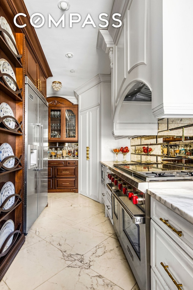 205 W 89th St Unit 6Rs, New York City, NY 10024 - kitchen featuring premium appliances, decorative backsplash, custom exhaust hood, light marble finish floors, and open shelves