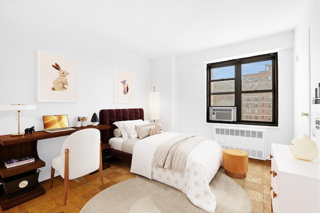 bedroom with radiator heating unit and cooling unit