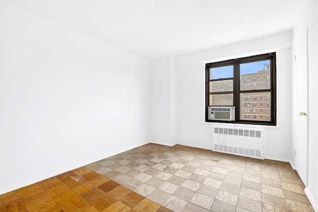 spare room featuring radiator and cooling unit