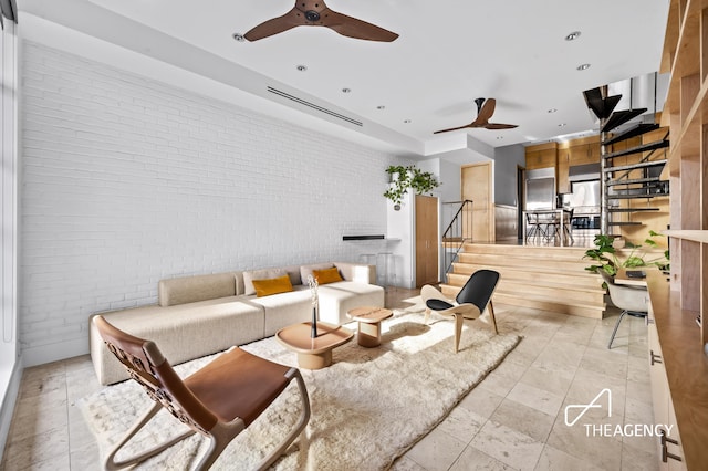 living area with brick wall, a ceiling fan, stairway, and recessed lighting