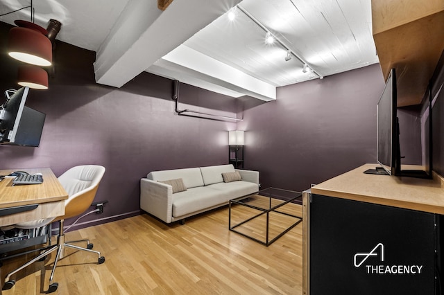 office area featuring rail lighting, light wood-style flooring, and baseboards