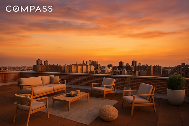 45 Overlook Ter Unit 7J, New York City, NY 10033 - patio terrace at dusk featuring a skyline view, an outdoor hangout area, and a balcony