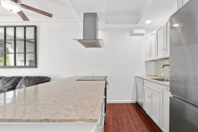 kitchen with appliances with stainless steel finishes, crown molding, a sink, island range hood, and backsplash