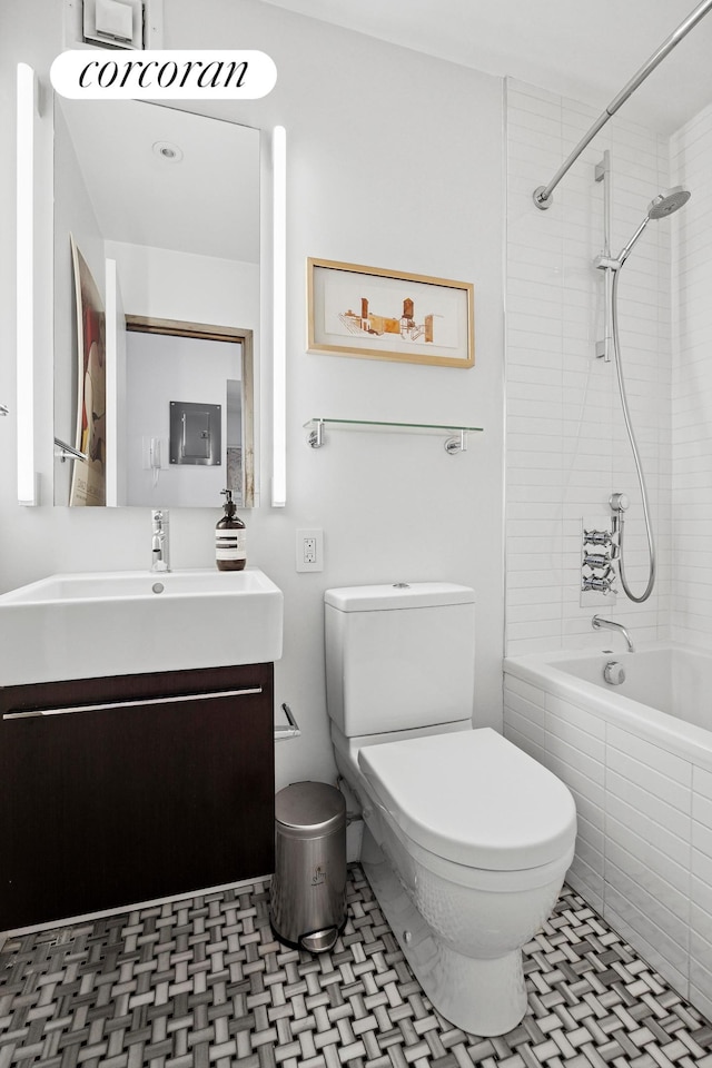 77 Bleecker St Unit 810, New York City, NY 10012 - bathroom featuring toilet, vanity, tiled shower / bath, and tile patterned floors