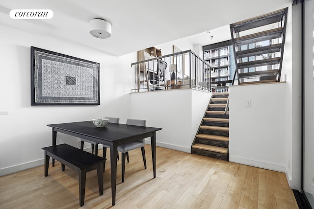 77 Bleecker St Unit 810, New York City, NY 10012 - dining area featuring stairs, hardwood / wood-style flooring, and baseboards