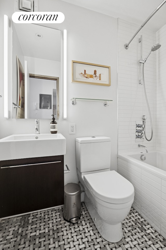 77 Bleecker St Unit 810, New York City, NY 10012 - full bath featuring toilet, vanity, tiled shower / bath, and tile patterned floors