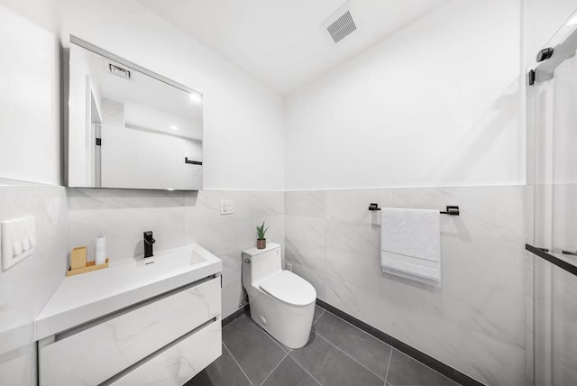 46-40 Vernon Blvd Unit 5-A, New York City, NY 11101 - bathroom with tile walls, vanity, toilet, tile patterned floors, and wainscoting