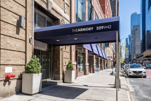 529 W 42nd St Unit 6F, New York City, NY 10036 - view of exterior entry featuring brick siding and a view of city