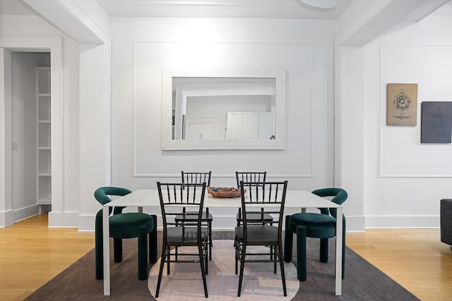 dining room with baseboards and wood finished floors