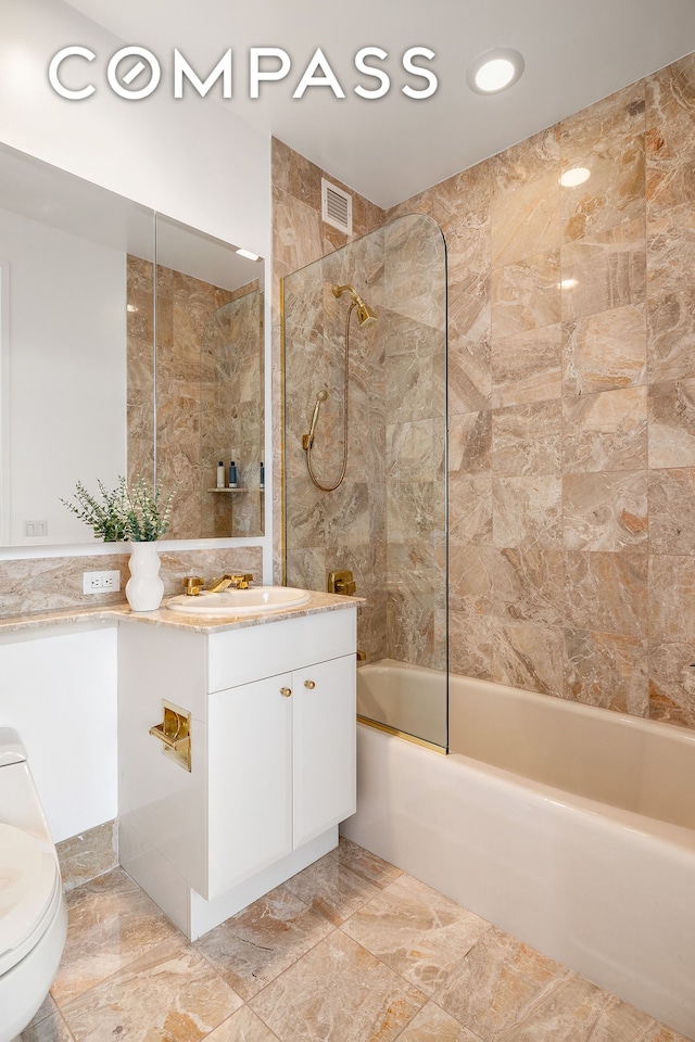 bathroom featuring shower / washtub combination, vanity, and toilet