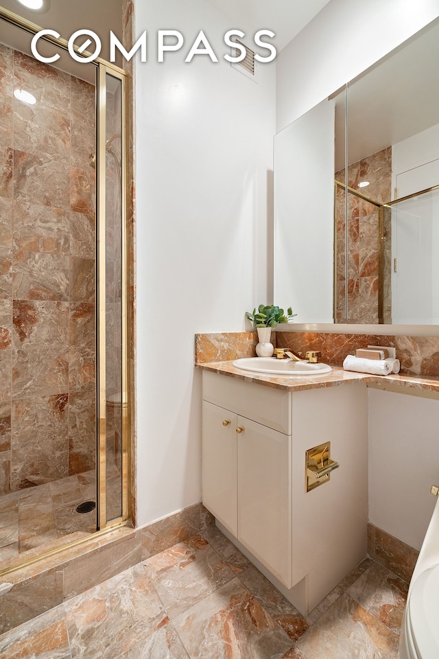 full bathroom featuring a stall shower and vanity