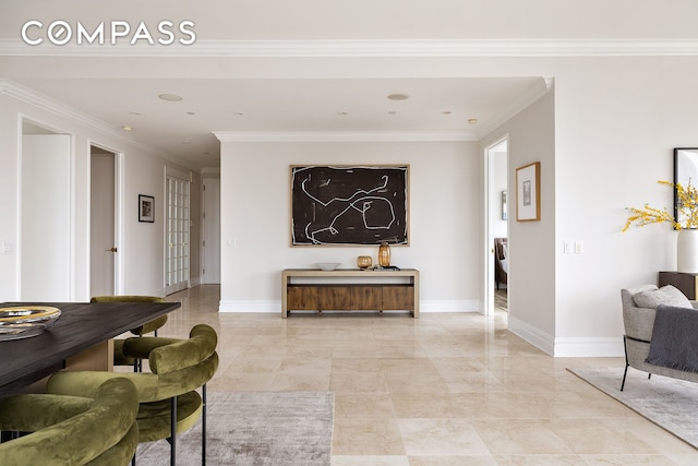 hall featuring ornamental molding, baseboards, and light marble finish flooring