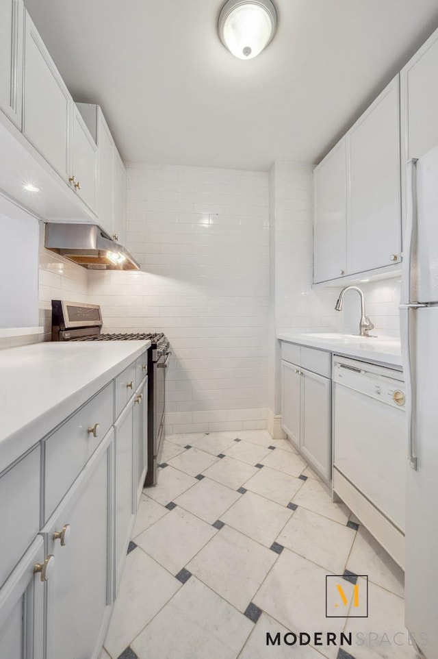 4-74 48th Ave Unit 8-M, New York City, NY 11109 - kitchen with white appliances, light countertops, under cabinet range hood, a sink, and tasteful backsplash