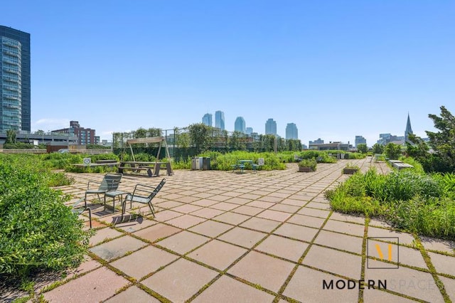 4-74 48th Ave Unit 8-M, New York City, NY 11109 - view of patio featuring a skyline view
