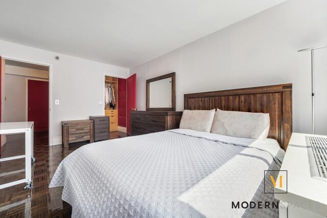 4-74 48th Ave Unit 8-M, New York City, NY 11109 - bedroom with baseboards, wood finished floors, and a closet
