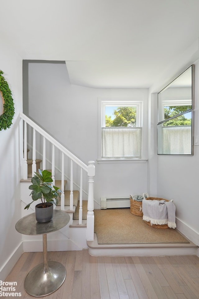4601 Henry Hudson Pkwy Unit A7, New York City, NY 10471 - staircase featuring a baseboard heating unit, wood finished floors, and baseboards