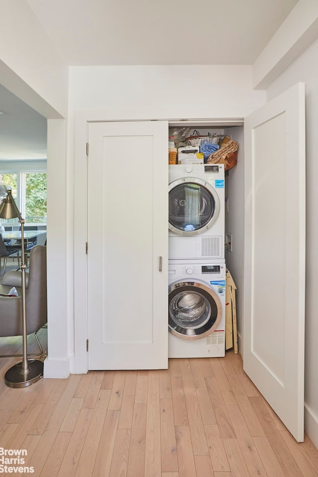 4601 Henry Hudson Pkwy Unit A7, New York City, NY 10471 - laundry area featuring stacked washer / dryer and light wood-type flooring
