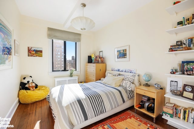 bedroom with wood-type flooring and baseboards