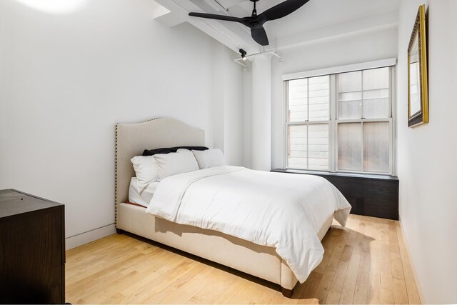 bedroom with baseboards, wood finished floors, and ceiling fan