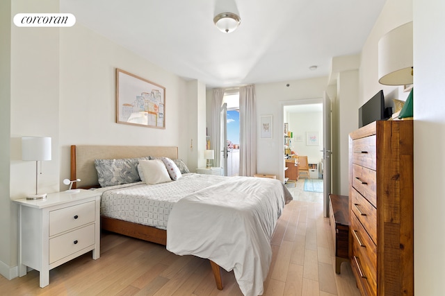 bedroom featuring light wood-style flooring and access to outside