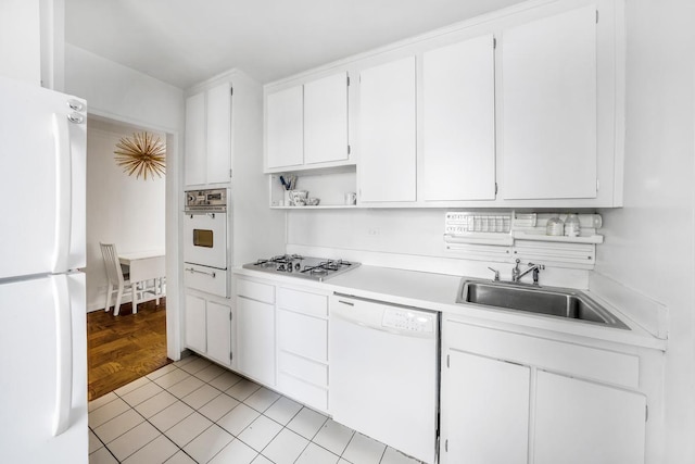 420 E 72nd St Unit 8C, New York City, NY 10021 - kitchen with light countertops, open shelves, a sink, white appliances, and white cabinetry