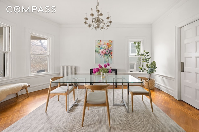 dining room featuring a notable chandelier, a wealth of natural light, and crown molding