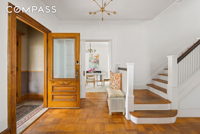447 E 17th St, New York City, NY 11226 - stairway with a chandelier and baseboards