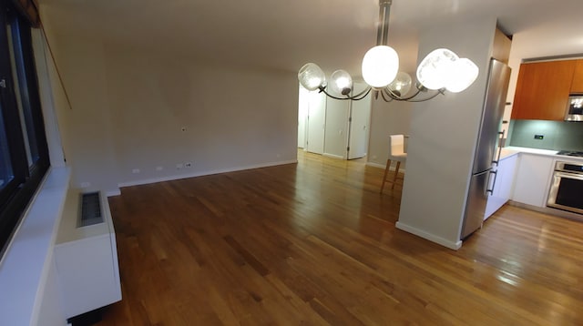 515 E 72nd St Unit 4B, New York City, NY 10021 - kitchen featuring appliances with stainless steel finishes, a chandelier, wood finished floors, and light countertops