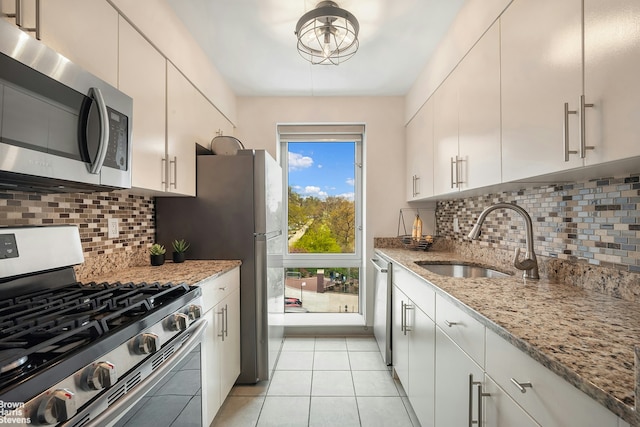 330 W 145th St Unit 505, New York City, NY 10039 - kitchen with appliances with stainless steel finishes, a sink, light tile patterned floors, tasteful backsplash, and light stone countertops