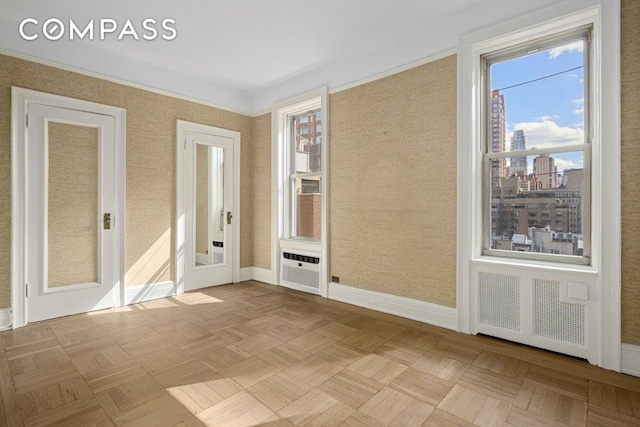 156 E 79th St Unit 9C, New York City, NY 10075 - unfurnished room featuring baseboards and a city view