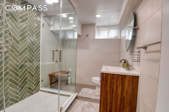 full bath featuring tile walls, a shower stall, and toilet