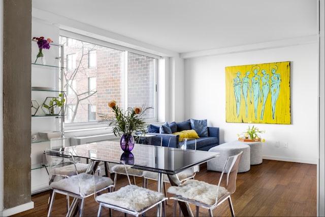dining room with baseboards and wood finished floors