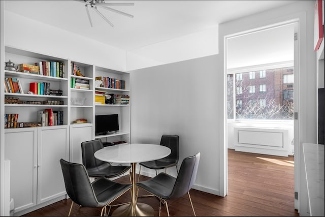dining room with baseboards and wood finished floors