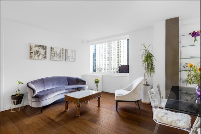 sitting room featuring baseboards and wood finished floors