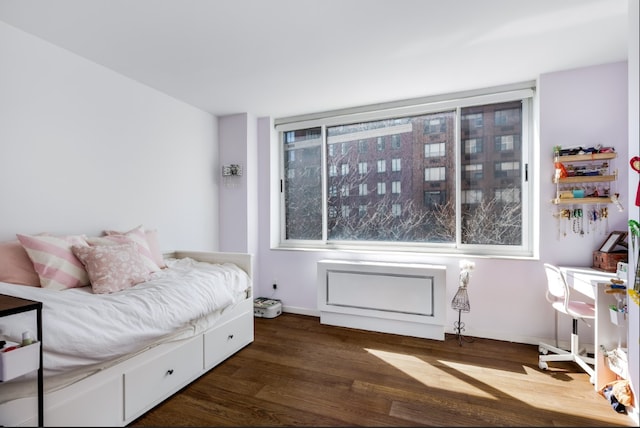 bedroom with baseboards and wood finished floors