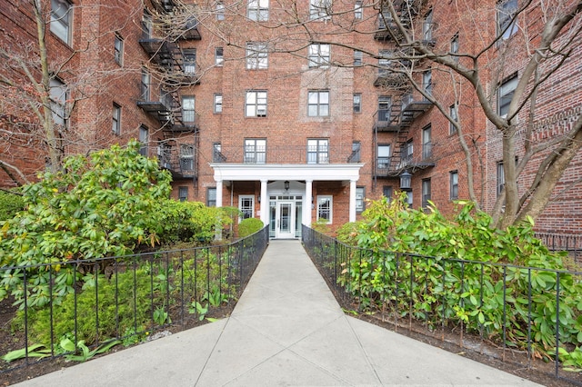 view of apartment building / complex with fence