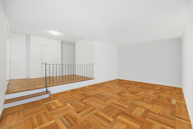 unfurnished room featuring baseboards